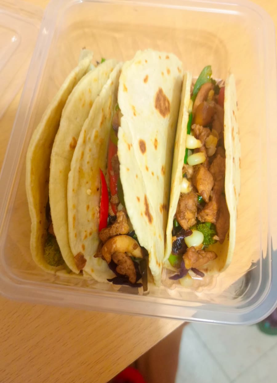 Packed meal-prep containers with chicken wraps